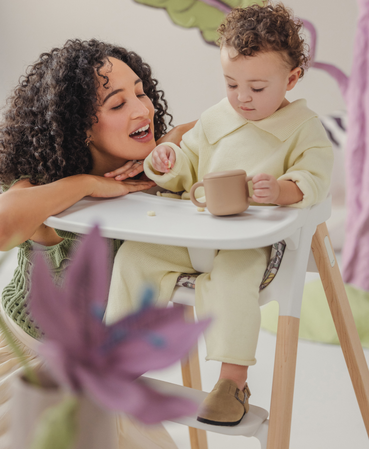 Mother connecting with child in Nuna's BRYN high chair